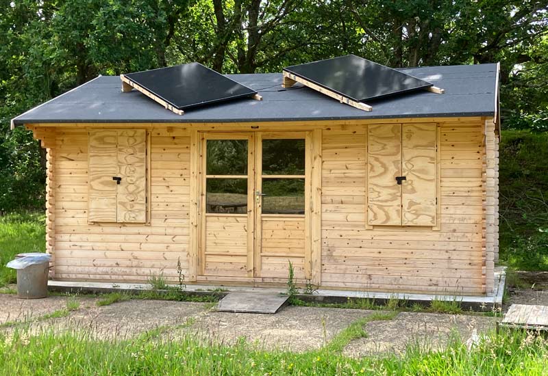 Owls Hoot log cabin camping area at Sandy Acres